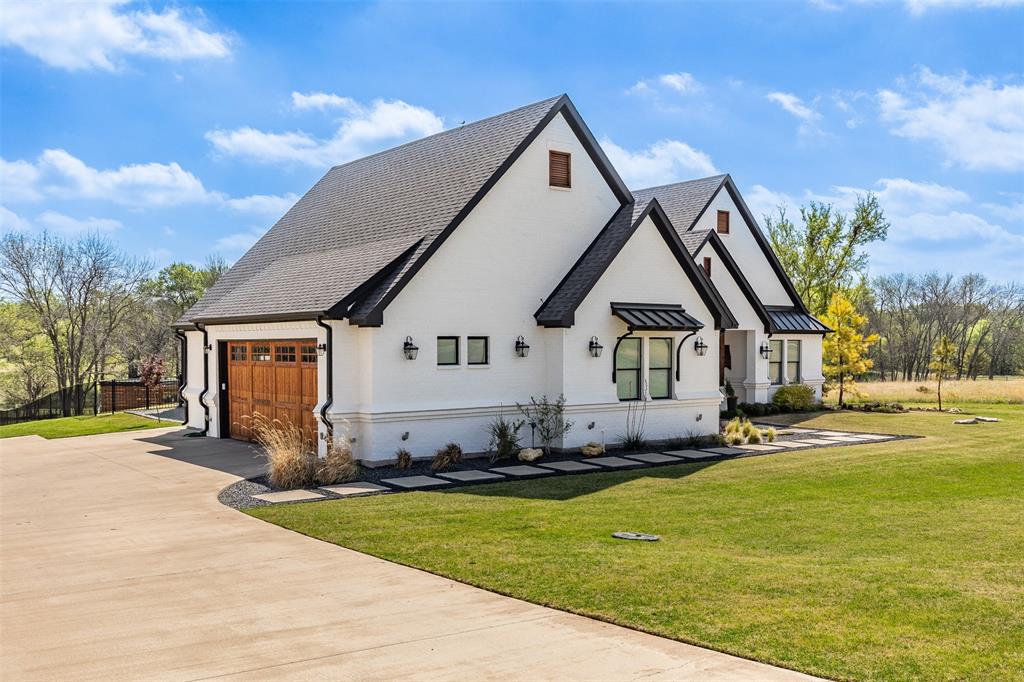 108 Golf Walk Circle Denison, TX 75020 - Photo 2 of 40 a front view of house with yard and trees in the background