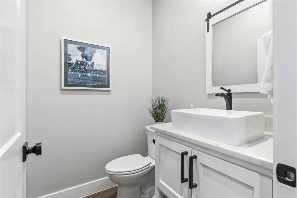 108 Golf Walk Circle Denison, TX 75020 - Photo 23 of 40 a bathroom with a sink a toilet and a mirror