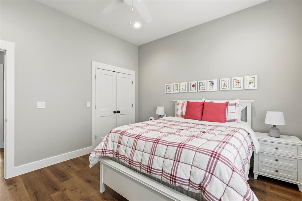 108 Golf Walk Circle Denison, TX 75020 - Photo 27 of 40 a bedroom with a bed and a table