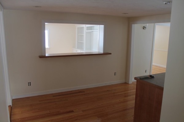 9 Birch Road Natick, MA 01760 - Photo 4 of 10 a view of an empty room with wooden floor and a window