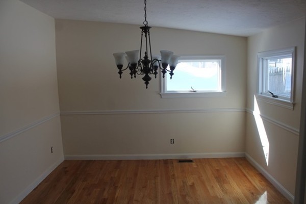 9 Birch Road Natick, MA 01760 - Photo 8 of 10 an empty room with a window and chandelier fan