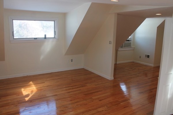 9 Birch Road Natick, MA 01760 - Photo 9 of 10 an empty room with wooden floor and windows