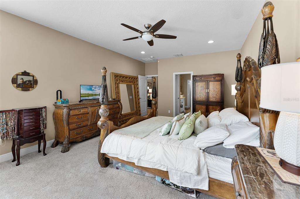 1208 Fieldstone Circle Oviedo, FL 32765 - Photo 25 of 43 a bedroom with a bed and a chandelier