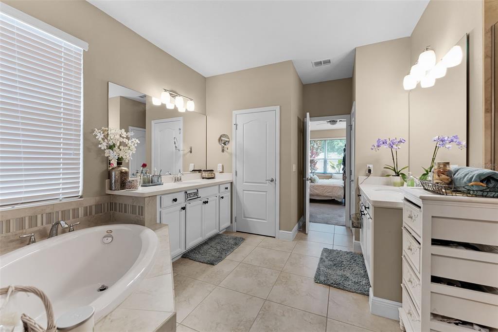 1208 Fieldstone Circle Oviedo, FL 32765 - Photo 27 of 43 a bathroom with a tub a sink and a mirror