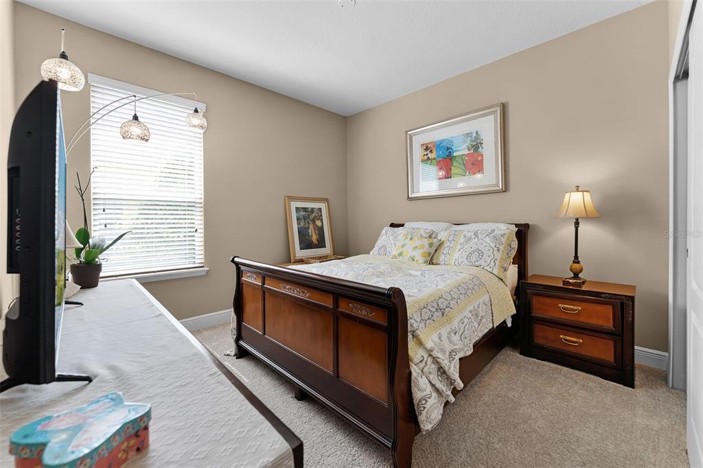 1208 Fieldstone Circle Oviedo, FL 32765 - Photo 30 of 43 a spacious bedroom with a bed and a lamp on the dresser
