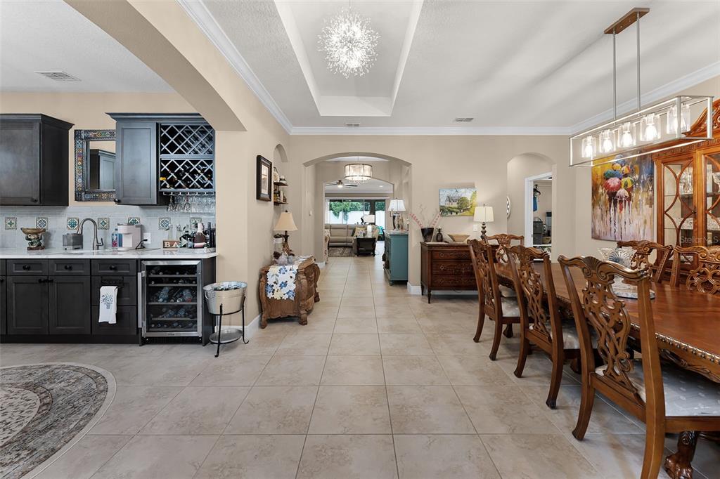 1208 Fieldstone Circle Oviedo, FL 32765 - Photo 3 of 43 a living room with furniture a chandelier and kitchen view