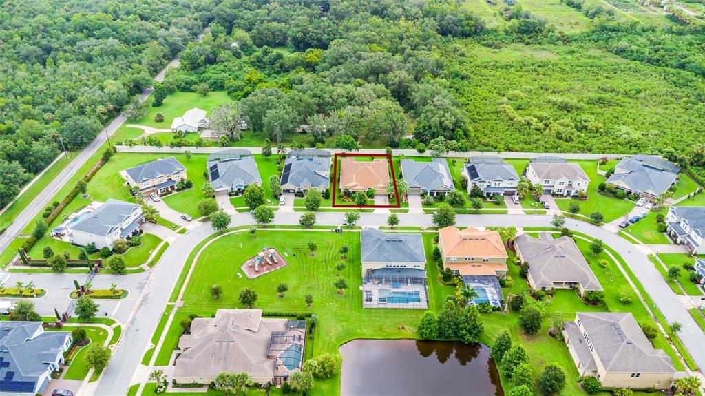 1208 Fieldstone Circle Oviedo, FL 32765 - Photo 38 of 43 an aerial view of a house with a garden and lake view