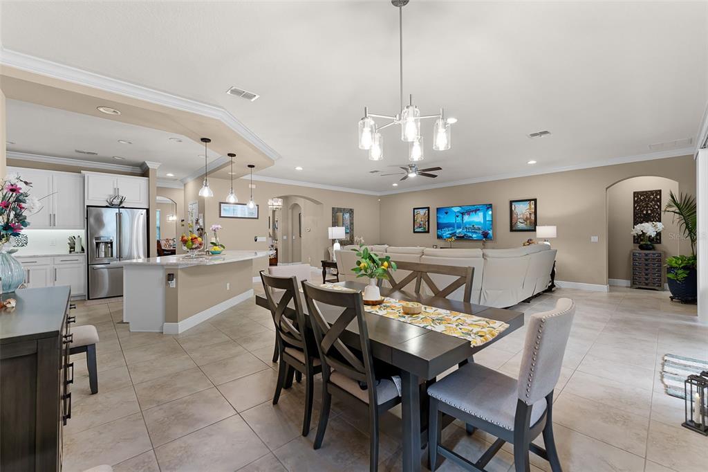 1208 Fieldstone Circle Oviedo, FL 32765 - Photo 5 of 43 a view of a dining room and livingroom with furniture a chandelier fan a kitchen and a chandelier