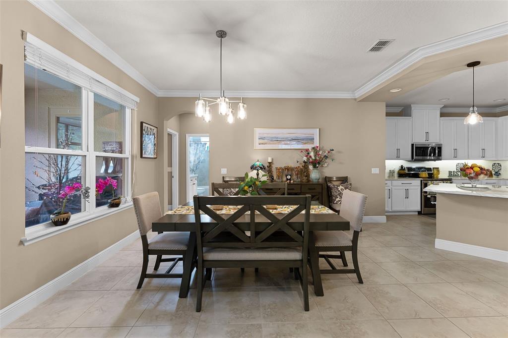 1208 Fieldstone Circle Oviedo, FL 32765 - Photo 9 of 43 a view of a dining room and livingroom with furniture wooden floor a chandelier