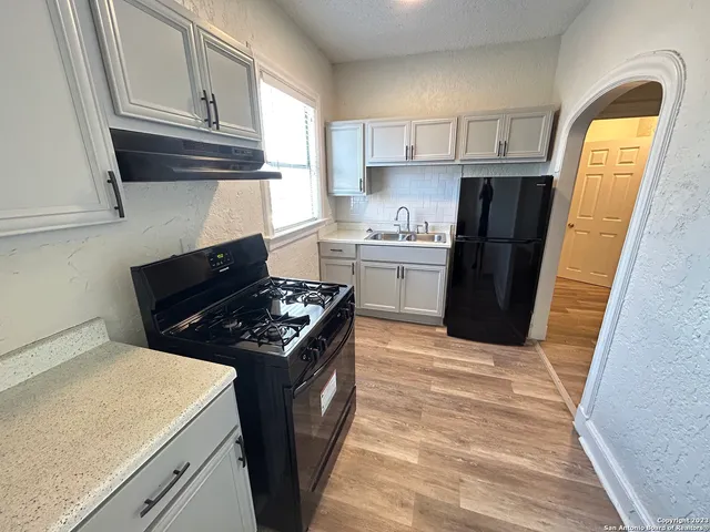 a kitchen with a stove and a refrigerator