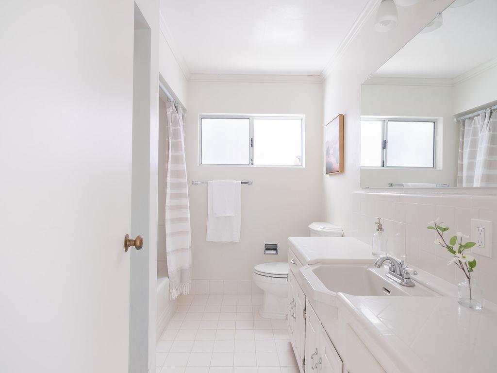264 Upland Road Redwood City, CA 94062 - Photo 13 of 31 a bathroom with a sink a toilet and shower