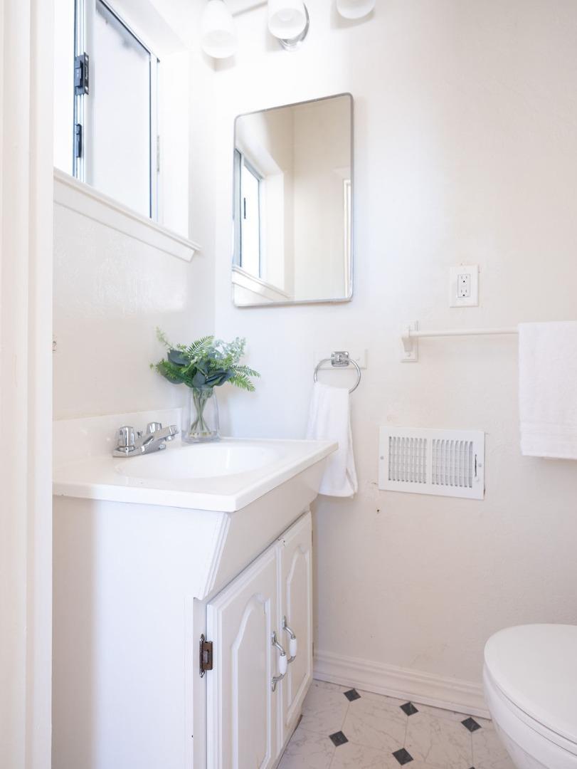 264 Upland Road Redwood City, CA 94062 - Photo 17 of 31 a bathroom with a sink a toilet and mirror