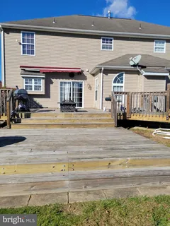 a view of a swimming pool with a lawn chairs under an umbrella