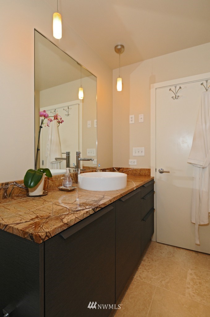 737 Olive Way, Unit 2809 Seattle, WA 98101 - Photo 13 of 24 a bathroom with a granite countertop sink and a mirror