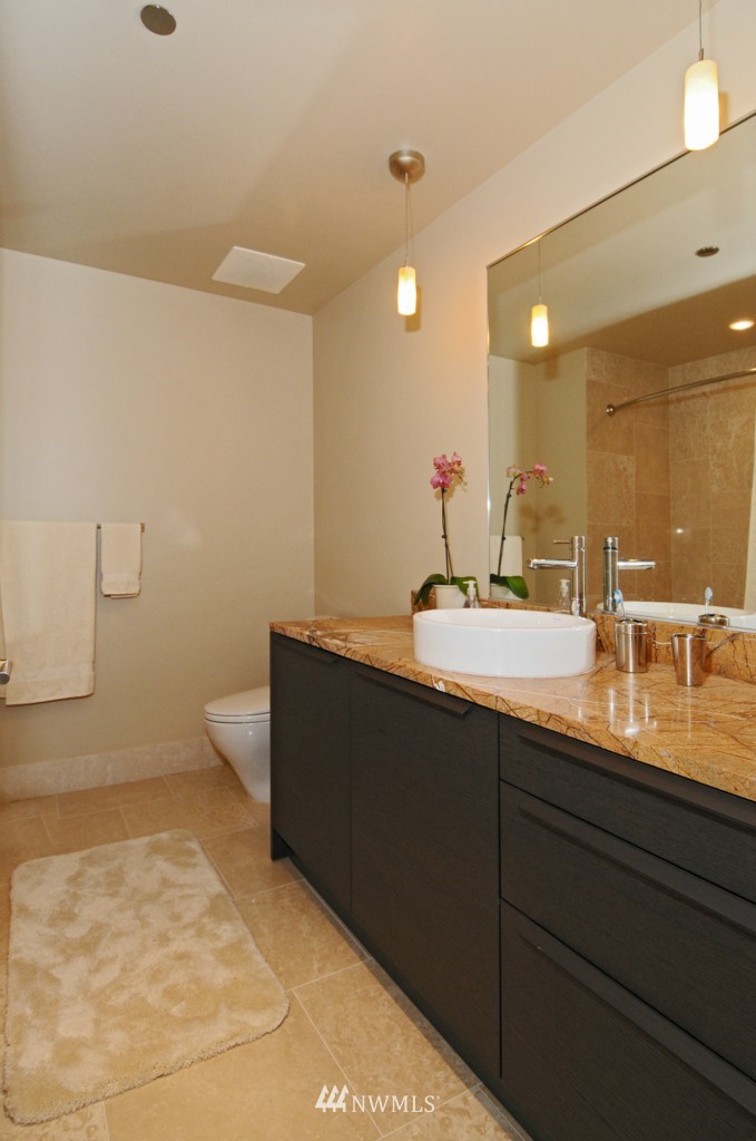 737 Olive Way, Unit 2809 Seattle, WA 98101 - Photo 14 of 24 a bathroom with a sink and a mirror