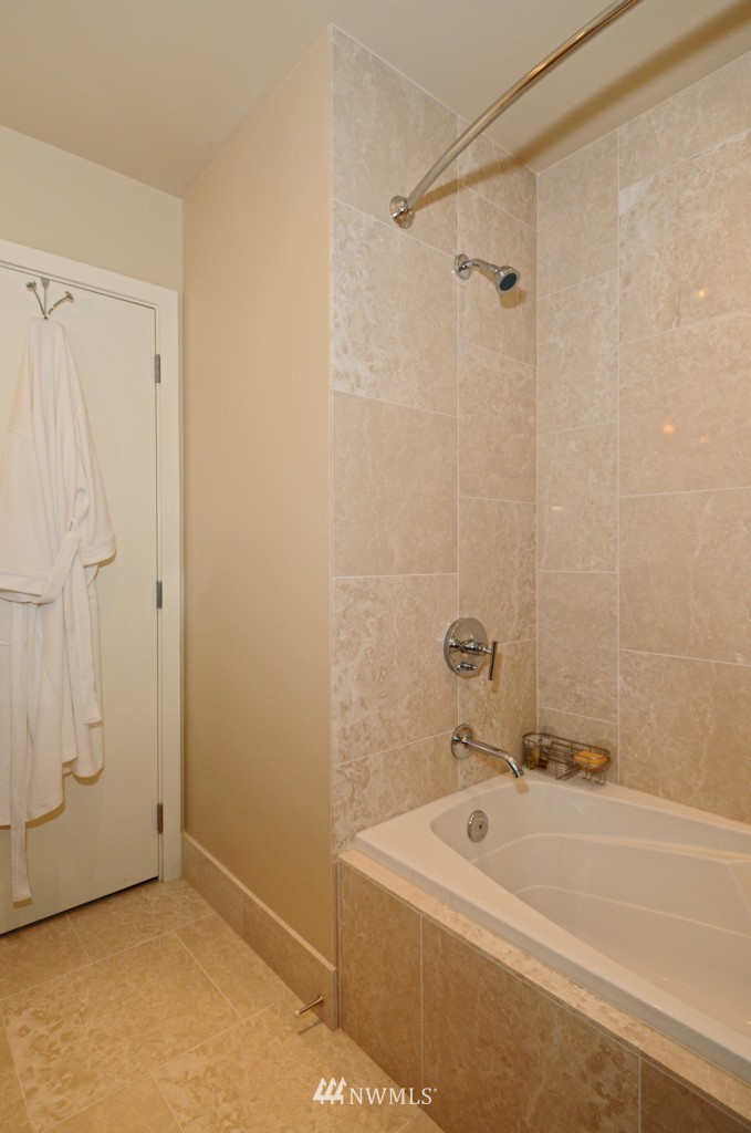 737 Olive Way, Unit 2809 Seattle, WA 98101 - Photo 15 of 24 a bathroom with a tub a sink and shower