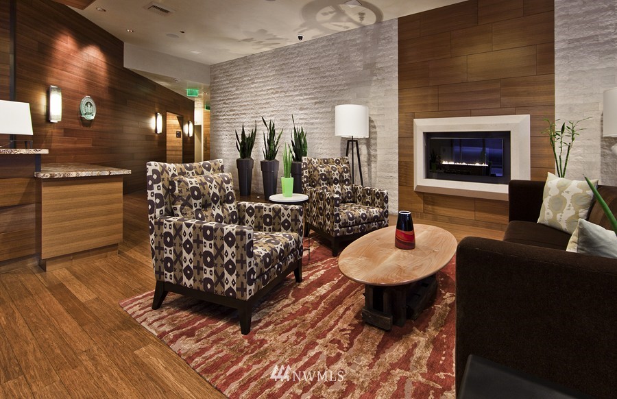 737 Olive Way, Unit 2809 Seattle, WA 98101 - Photo 18 of 24 a living room with furniture and a fireplace