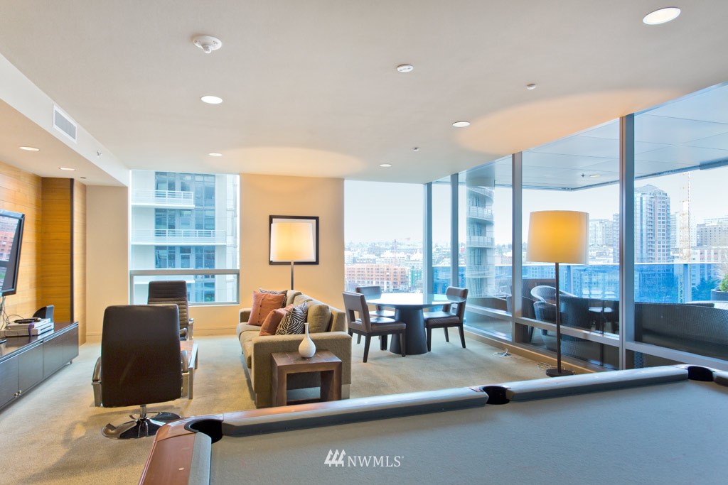 737 Olive Way, Unit 2809 Seattle, WA 98101 - Photo 21 of 24 a living room with fireplace furniture and floor to ceiling window