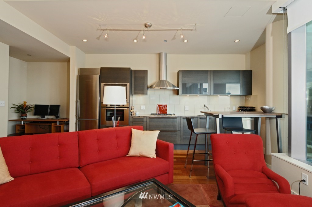 737 Olive Way, Unit 2809 Seattle, WA 98101 - Photo 4 of 24 a living room with furniture kitchen view and a window