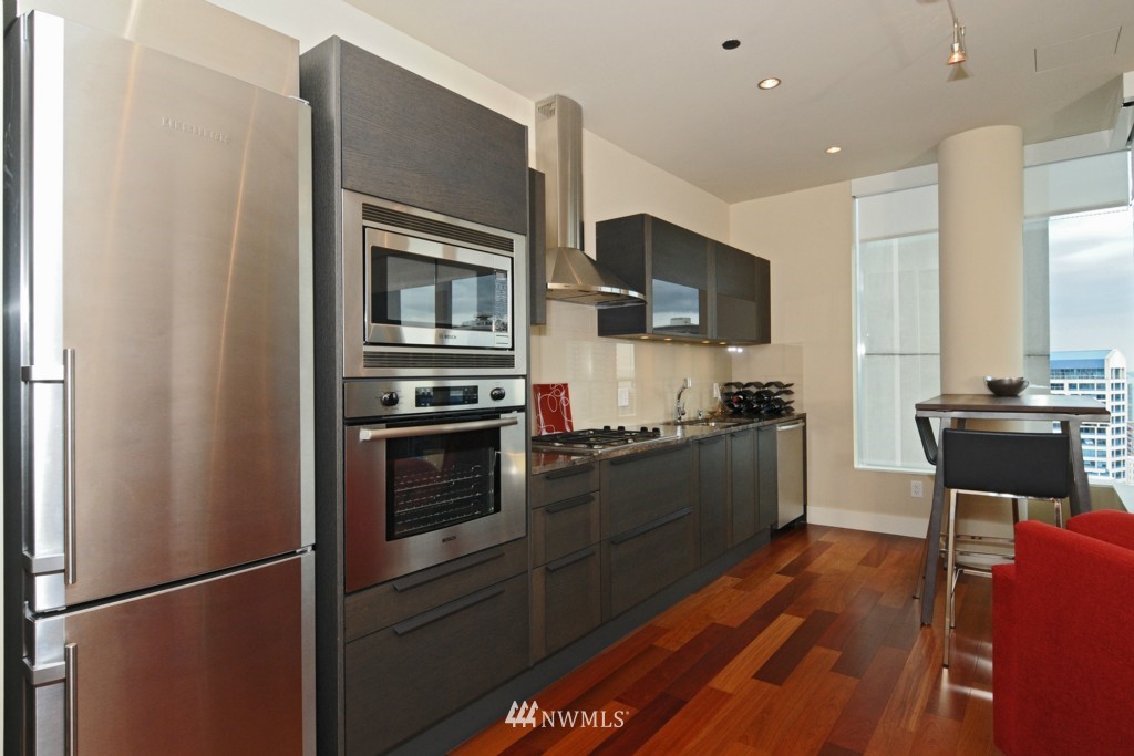 737 Olive Way, Unit 2809 Seattle, WA 98101 - Photo 8 of 24 a kitchen with stainless steel appliances a refrigerator stove and microwave