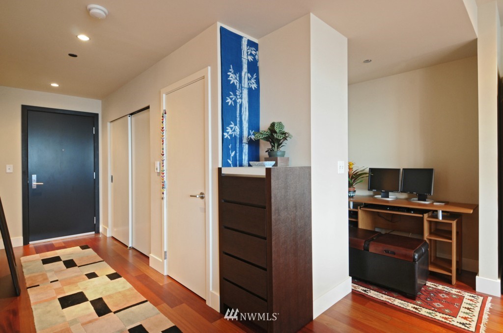 737 Olive Way, Unit 2809 Seattle, WA 98101 - Photo 9 of 24 a kitchen with a refrigerator and cabinets