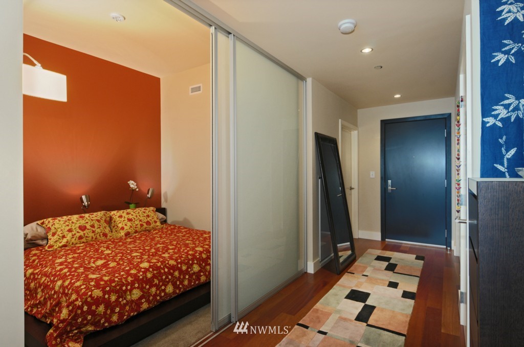 737 Olive Way, Unit 2809 Seattle, WA 98101 - Photo 10 of 24 a bedroom with a bed and a dresser