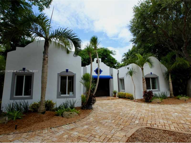 7975 Sunset Drive Miami, FL 33143 - Photo 1 of 21 a front view of house with a garden