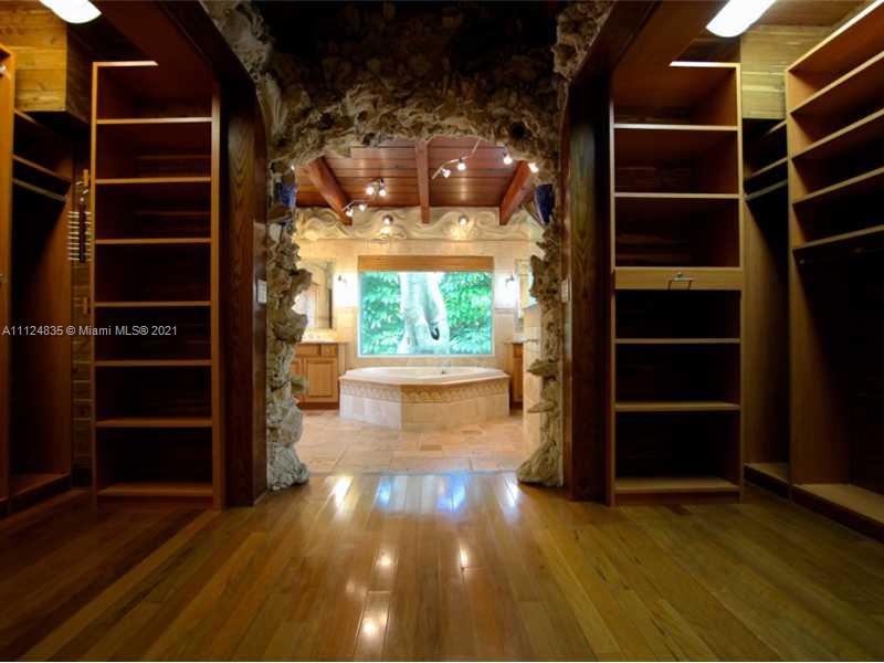 7975 Sunset Drive Miami, FL 33143 - Photo 11 of 21 a view of an empty room with a window and wooden floors