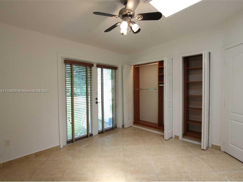 7975 Sunset Drive Miami, FL 33143 - Photo 13 of 21 wooden floor in an empty room with a window