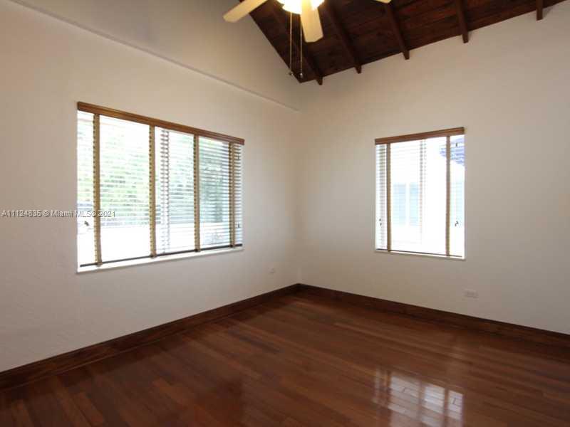 7975 Sunset Drive Miami, FL 33143 - Photo 14 of 21 an empty room with wooden floor and windows