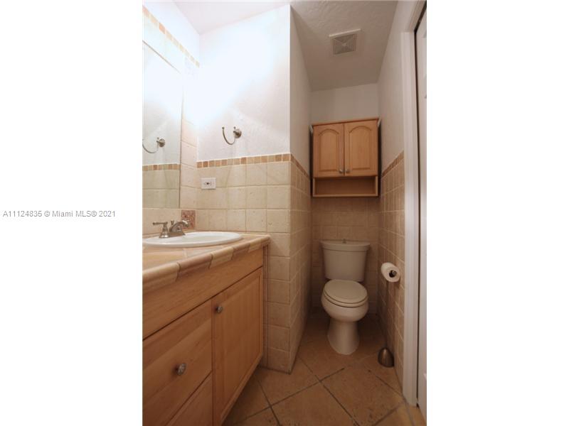 7975 Sunset Drive Miami, FL 33143 - Photo 15 of 21 a bathroom with a granite countertop toilet and a sink