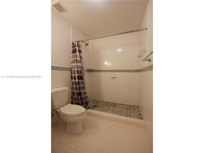 7975 Sunset Drive Miami, FL 33143 - Photo 17 of 21 a bathroom with a toilet and a shower