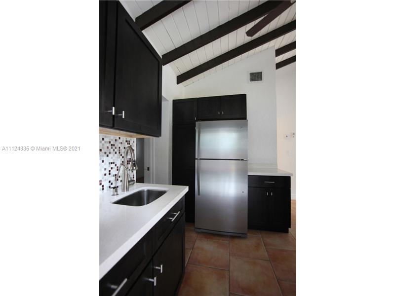 7975 Sunset Drive Miami, FL 33143 - Photo 19 of 21 a kitchen with a refrigerator and a sink