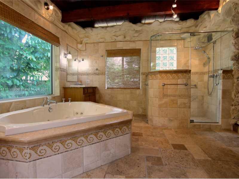 7975 Sunset Drive Miami, FL 33143 - Photo 10 of 21 a bath tub sitting next to a shower