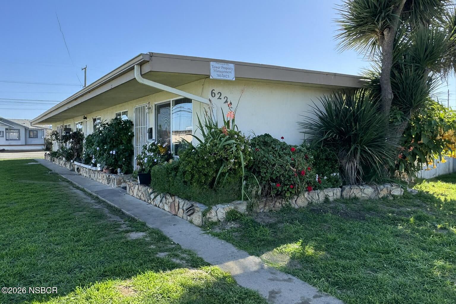 622 North B Street Lompoc, CA 93436 - Photo 2 of 7 a front view of house with yard and green space