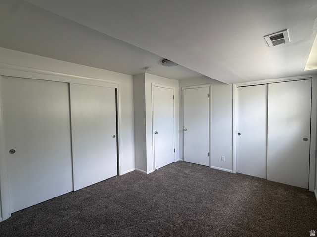 375 East 10560 South Sandy, UT 84070 - Photo 11 of 21 Carpeted interior space featuring white walls and multiple sliding closet doors