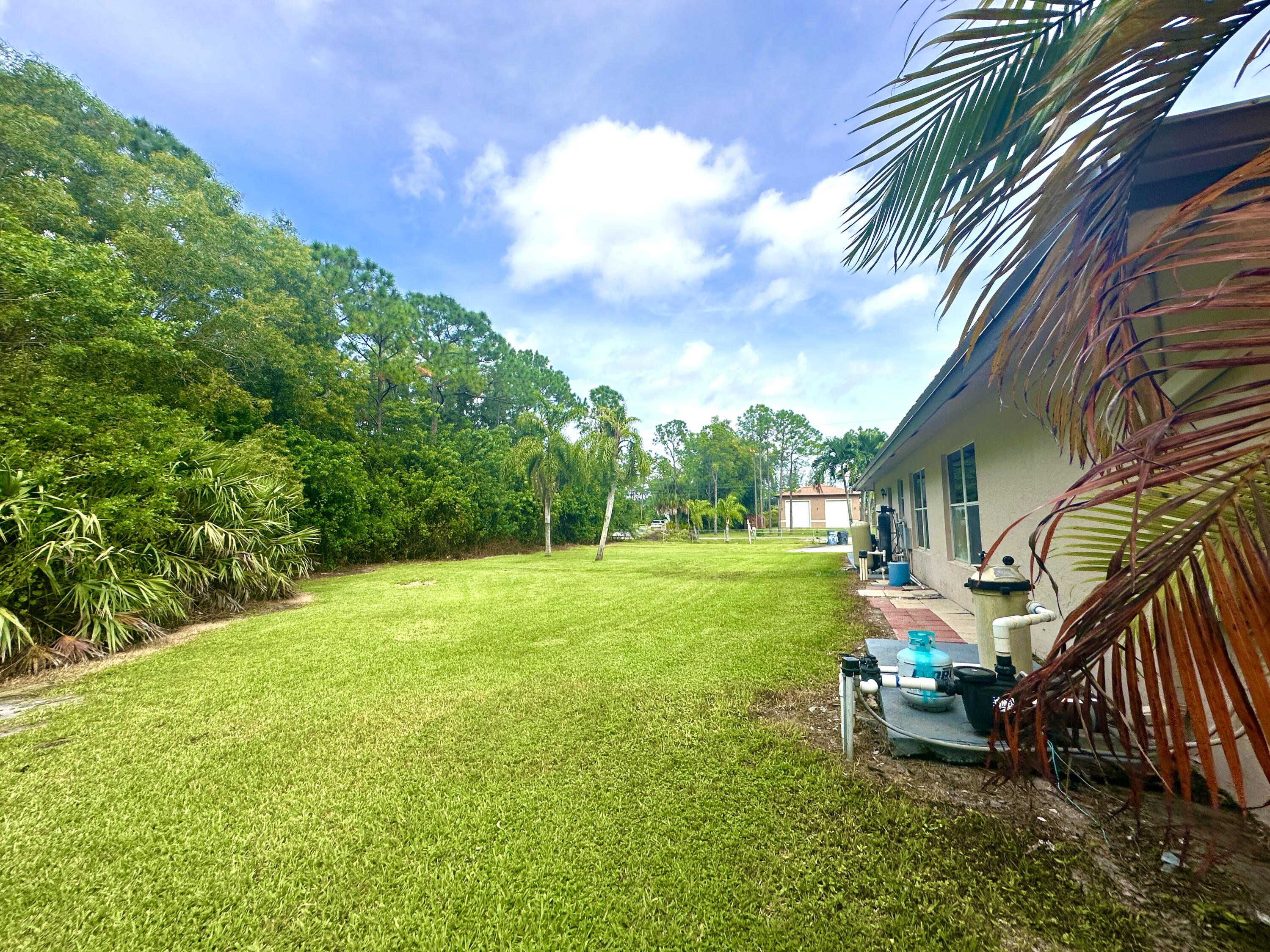 13338 76th Road North West Palm Beach, FL 33412 - Photo 105 of 138 a view of a house with a yard
