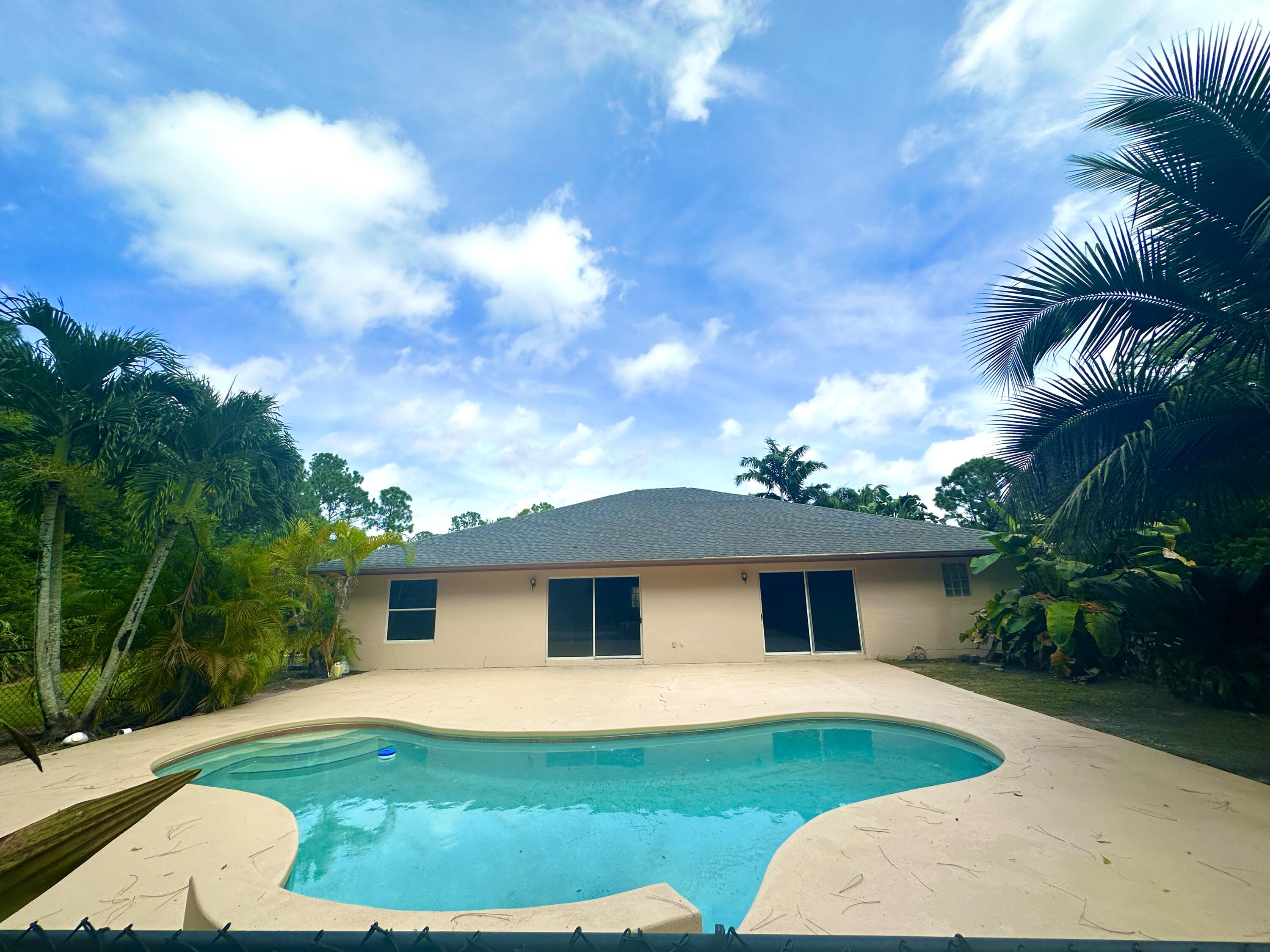 13338 76th Road North West Palm Beach, FL 33412 - Photo 108 of 138 a front view of a house with a garden