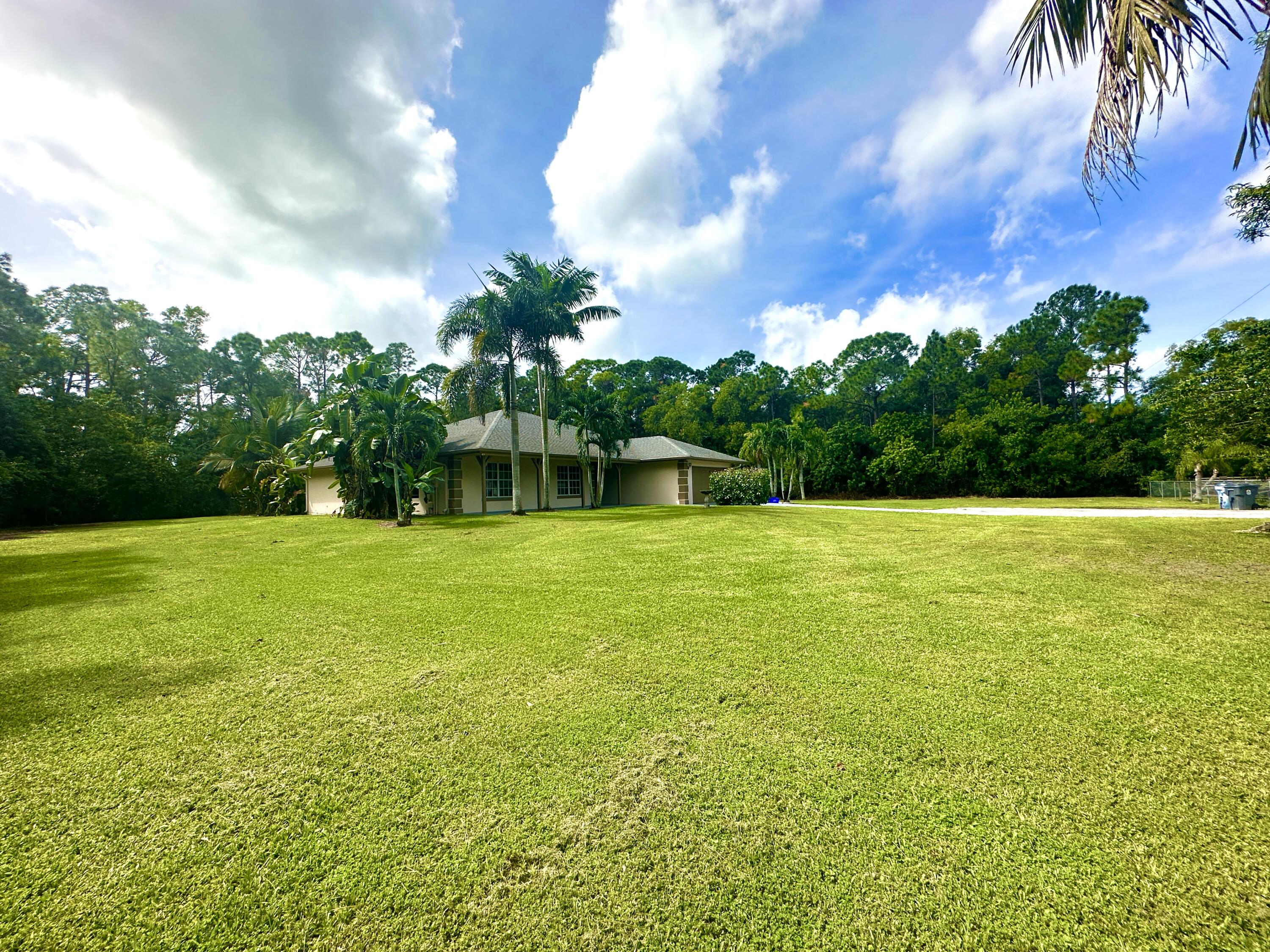 13338 76th Road North West Palm Beach, FL 33412 - Photo 110 of 138 a view of a swimming pool and a yard
