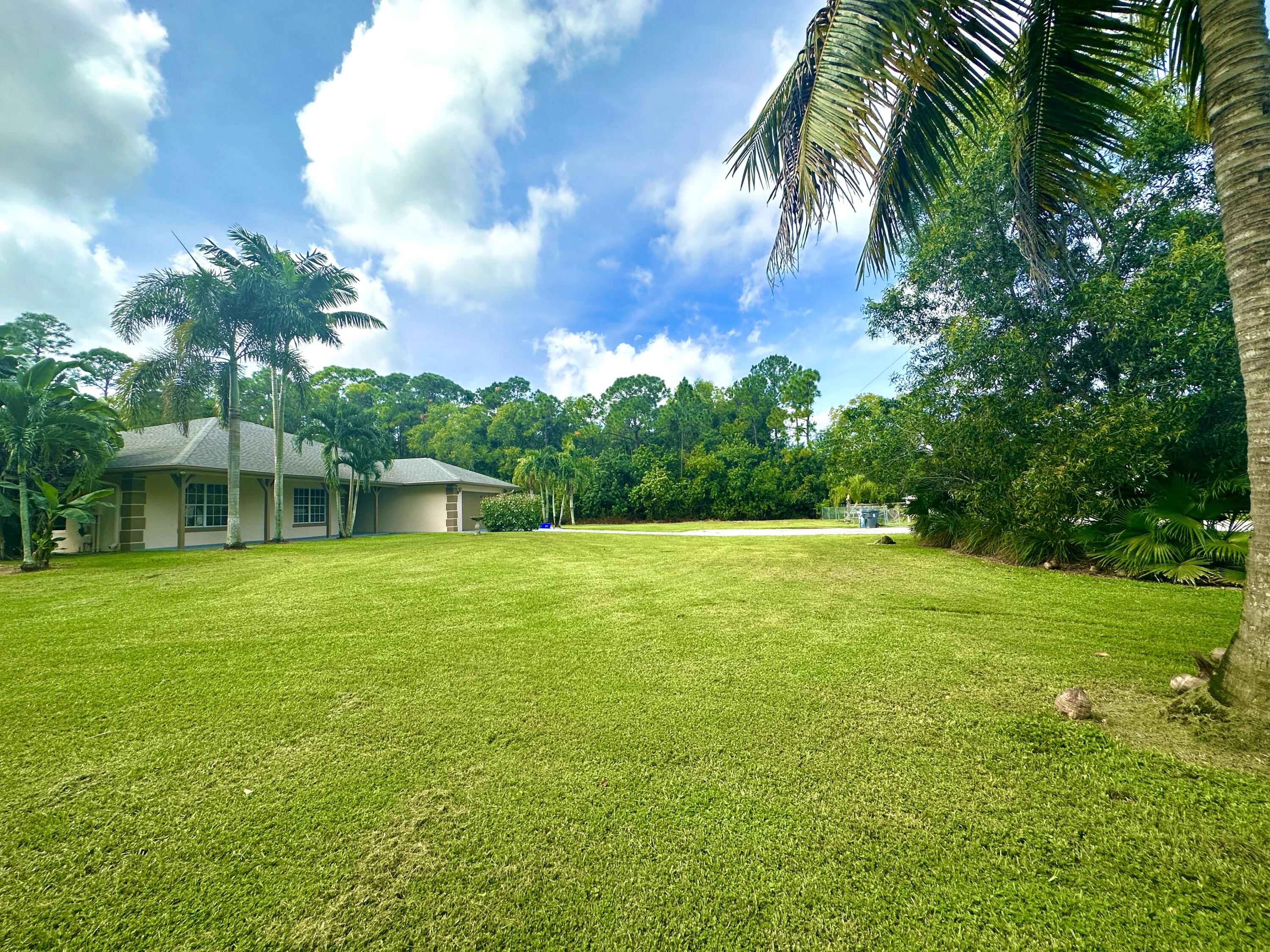 13338 76th Road North West Palm Beach, FL 33412 - Photo 112 of 138 a backyard of a house with lots of green space
