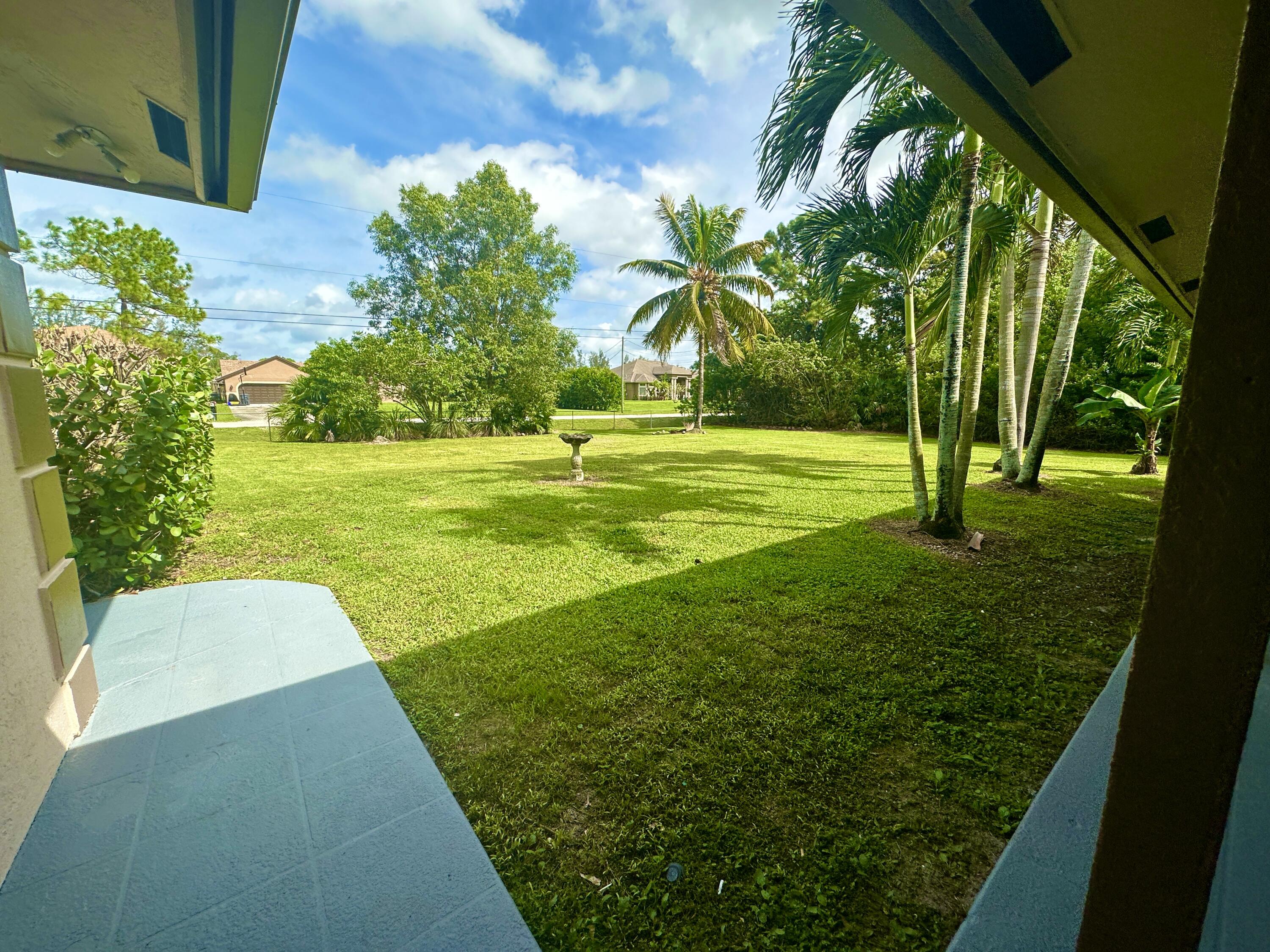 13338 76th Road North West Palm Beach, FL 33412 - Photo 114 of 138 a view of yard with swimming pool and green space