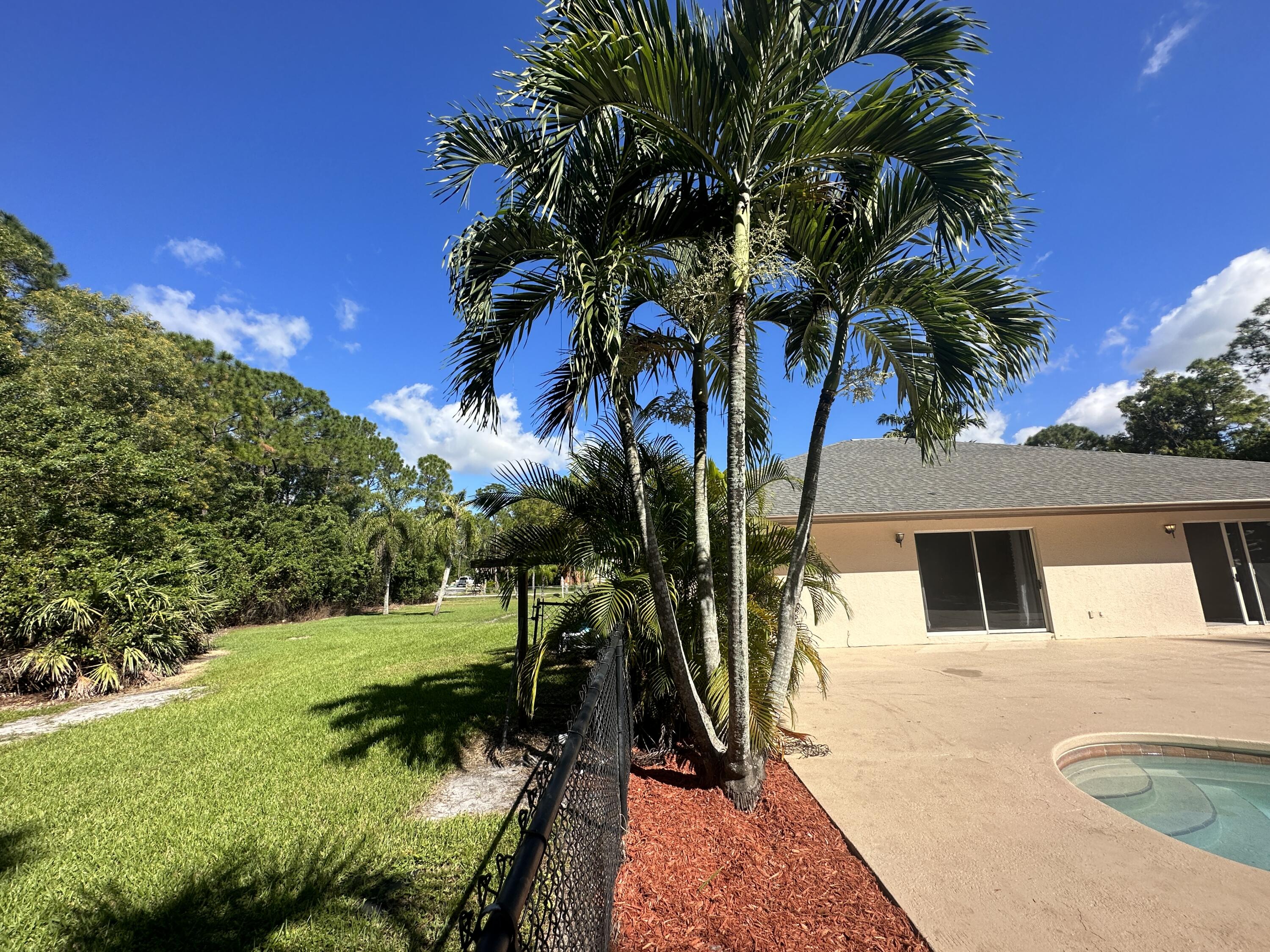 13338 76th Road North West Palm Beach, FL 33412 - Photo 133 of 138 a view of backyard with swimming pool and outdoor seating