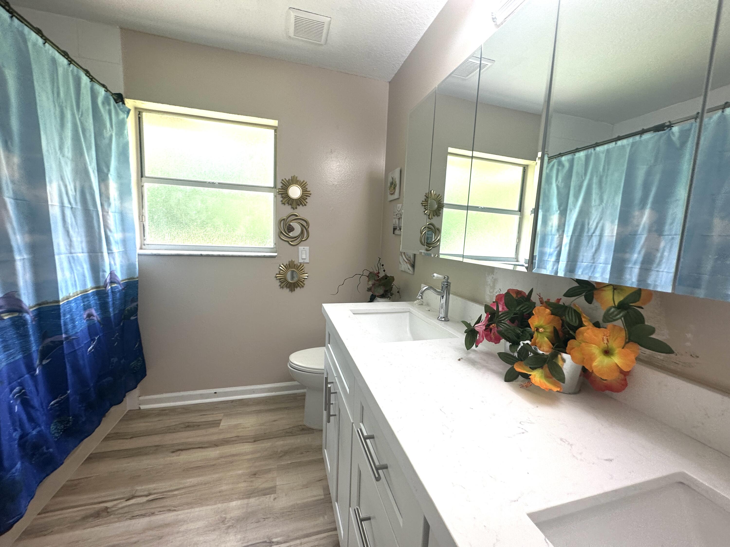 13338 76th Road North West Palm Beach, FL 33412 - Photo 19 of 138 a bathroom with a double vanity sink window and two mirror
