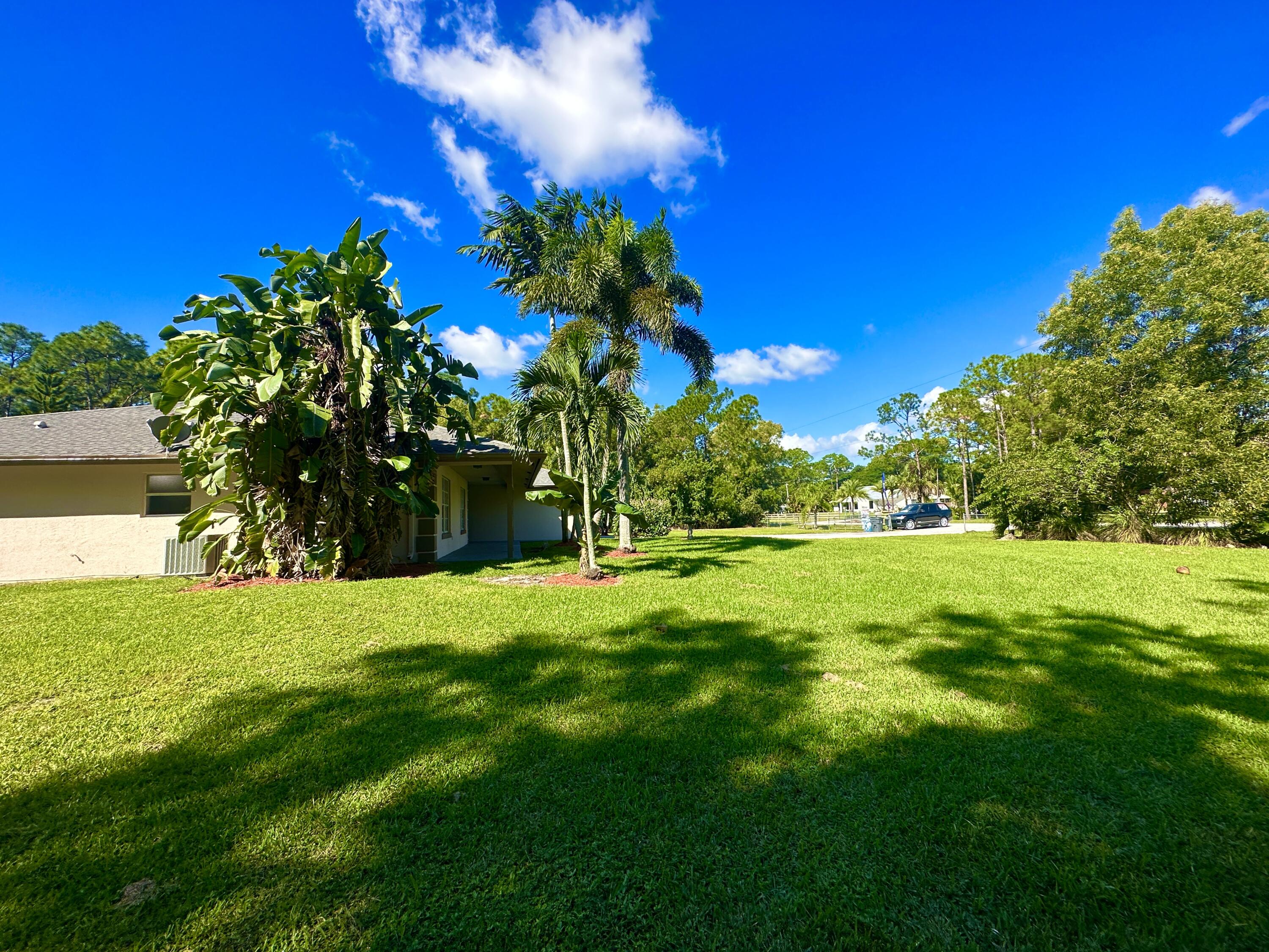 13338 76th Road North West Palm Beach, FL 33412 - Photo 2 of 138 a view of a yard with a house