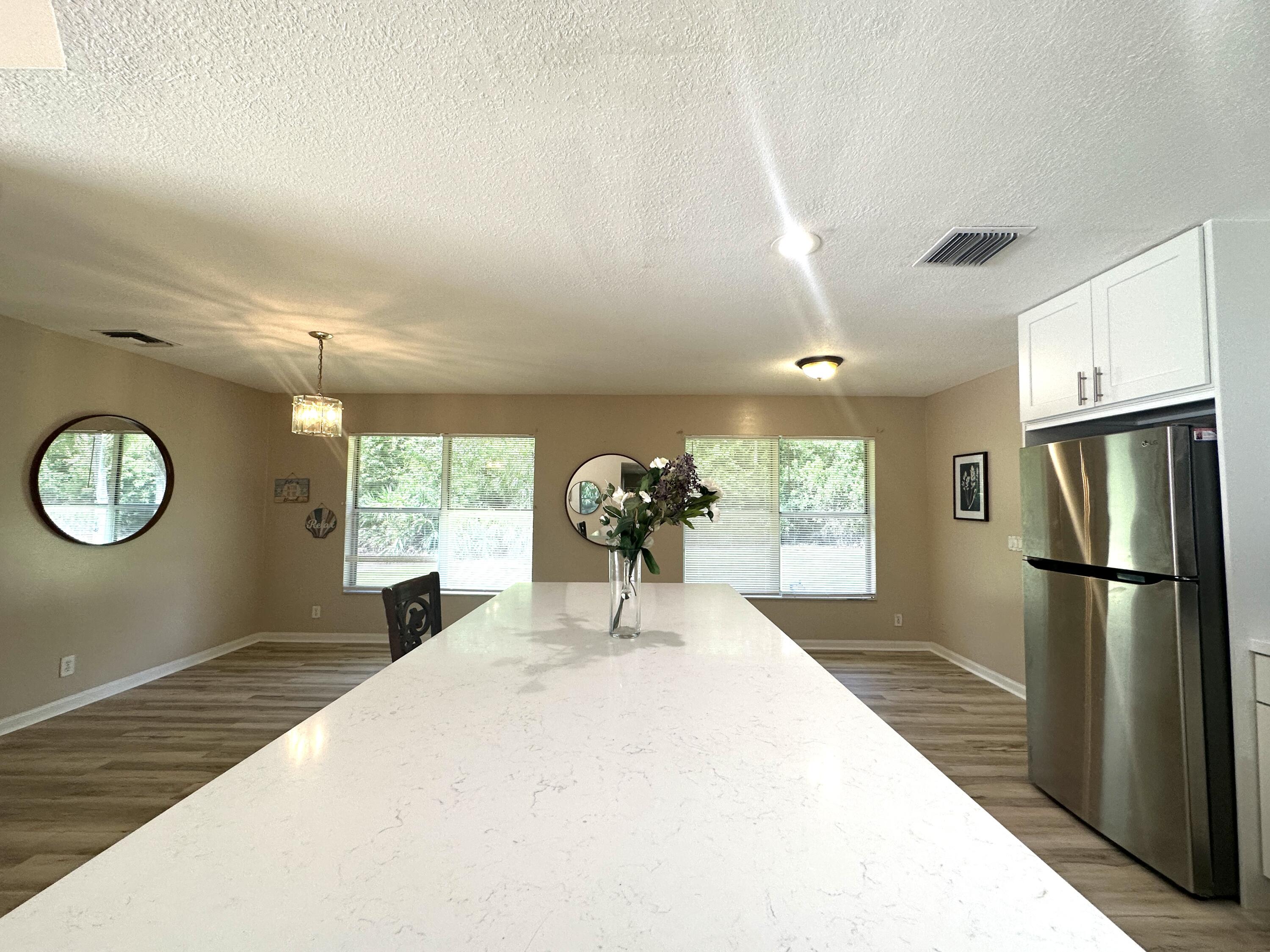 13338 76th Road North West Palm Beach, FL 33412 - Photo 25 of 138 a kitchen with stainless steel appliances a refrigerator and a fireplace