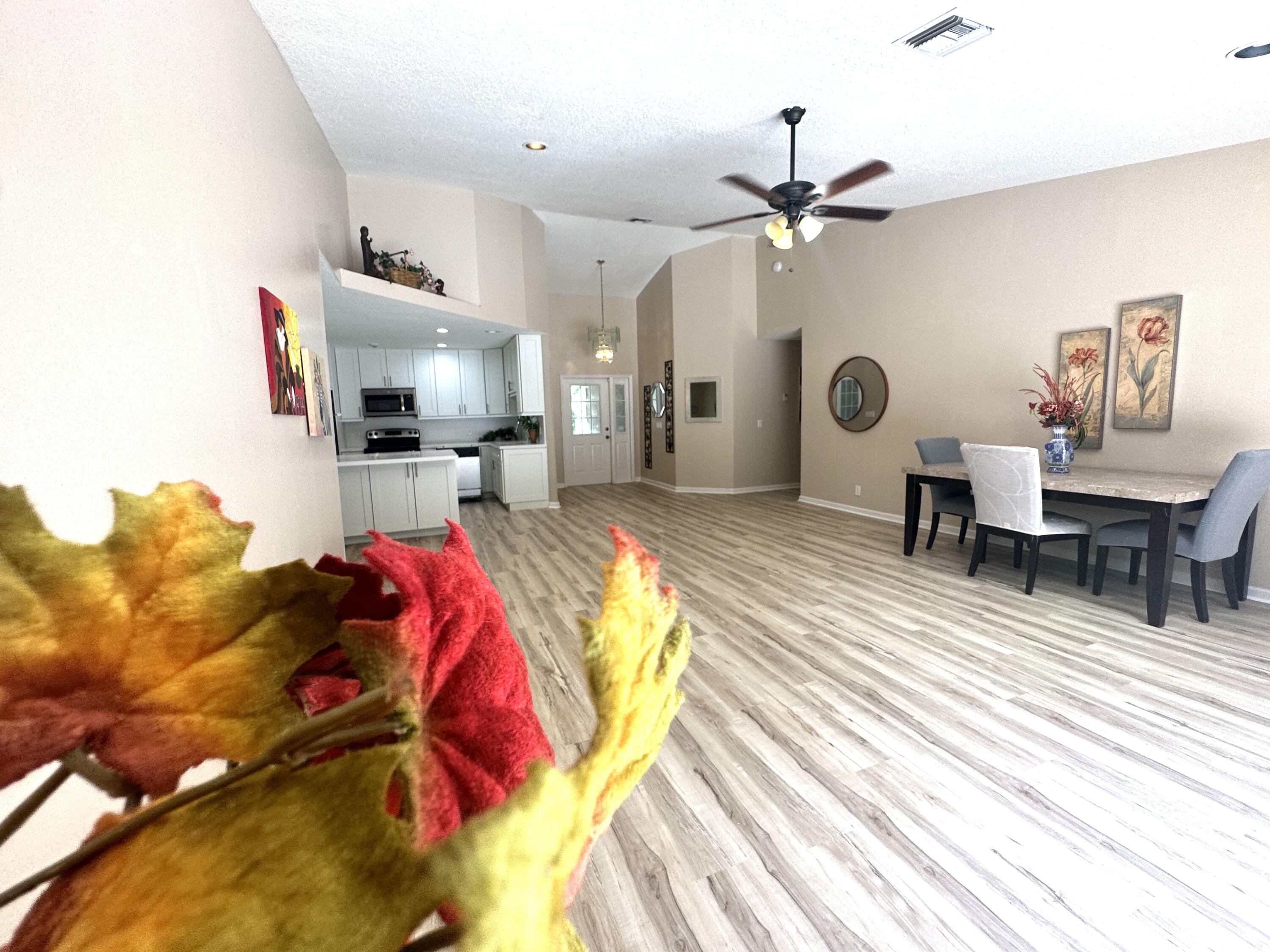 13338 76th Road North West Palm Beach, FL 33412 - Photo 3 of 138 a living room with patio furniture and a chandelier