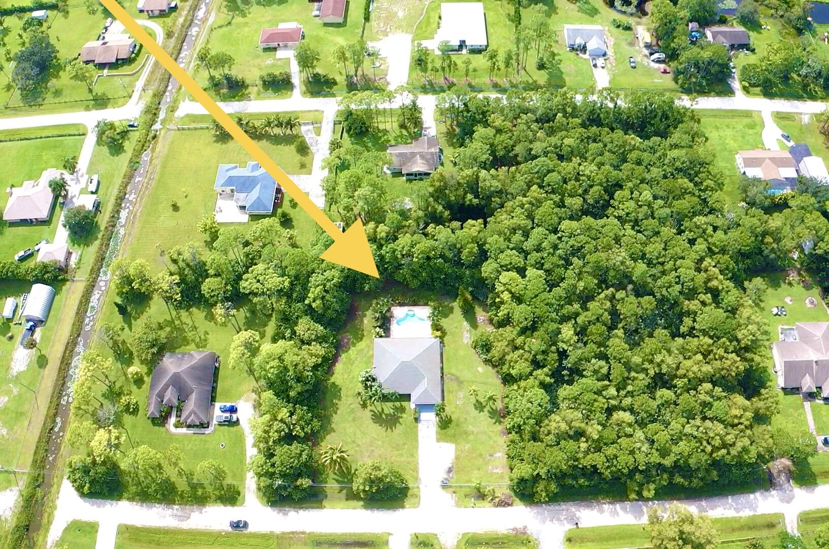 13338 76th Road North West Palm Beach, FL 33412 - Photo 31 of 138 a backyard of a house with a garden and plants