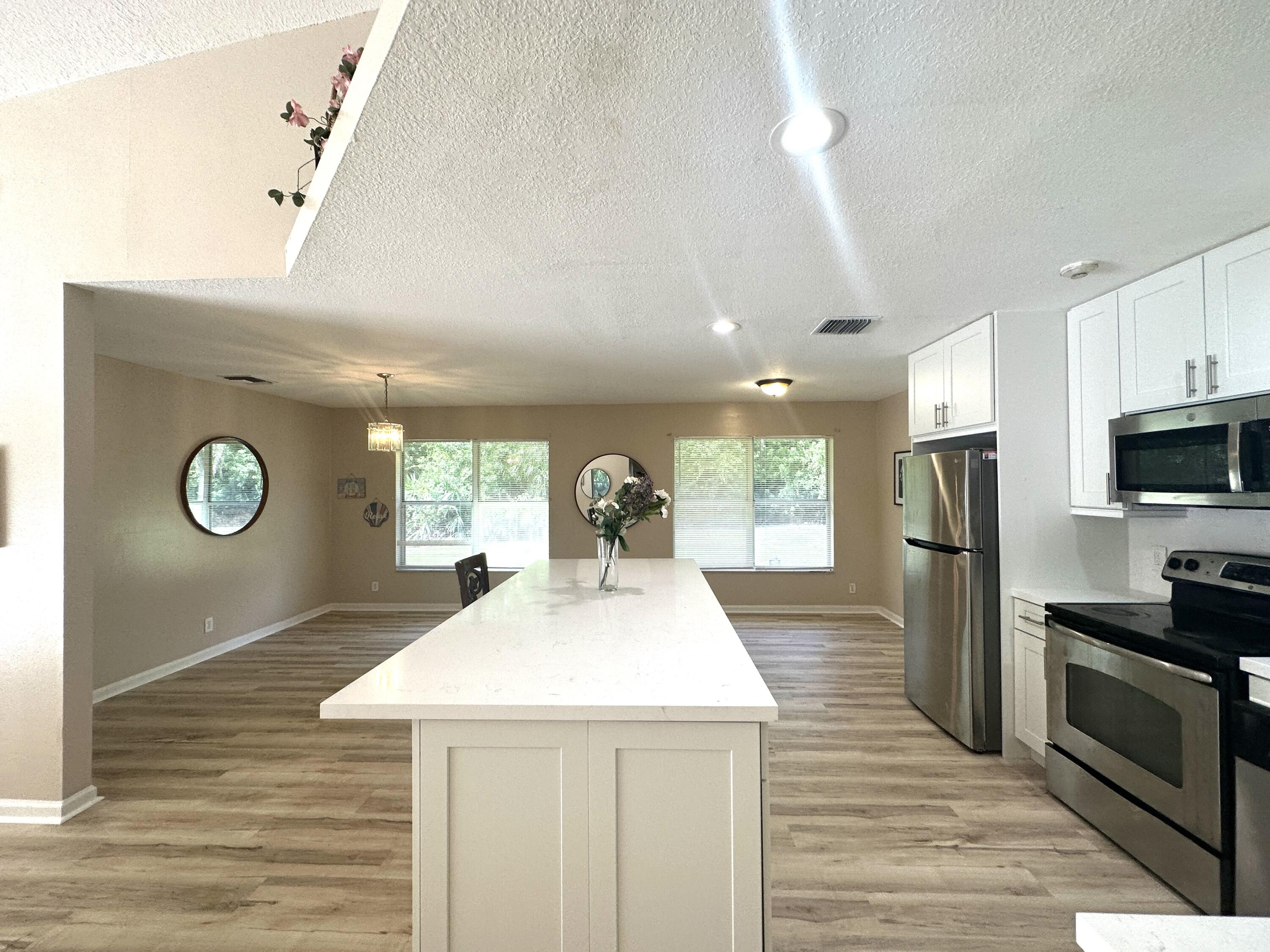 13338 76th Road North West Palm Beach, FL 33412 - Photo 6 of 138 a kitchen with a sink a stove top oven and refrigerator