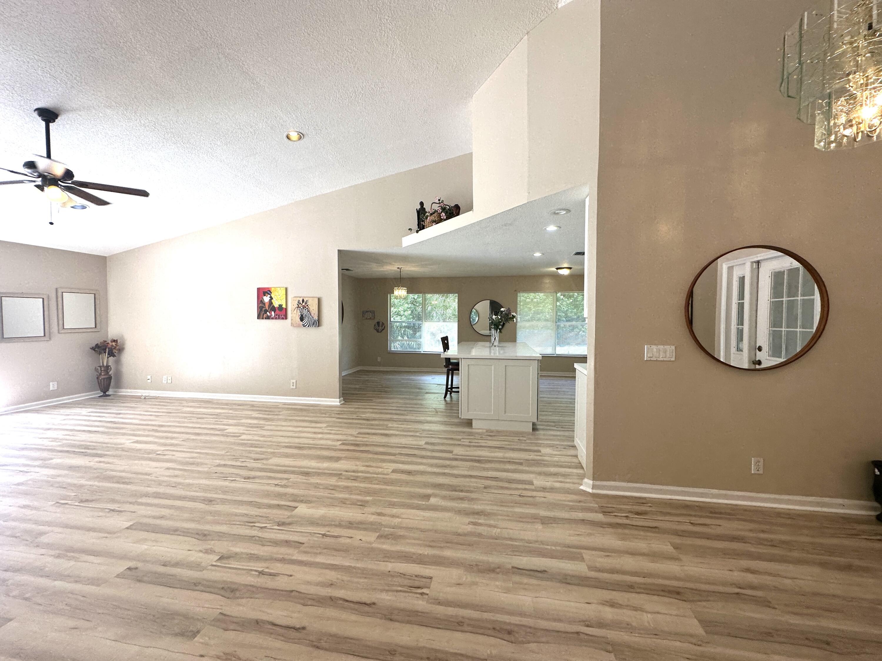 13338 76th Road North West Palm Beach, FL 33412 - Photo 69 of 138 a view of a living room and kitchen with wooden floor