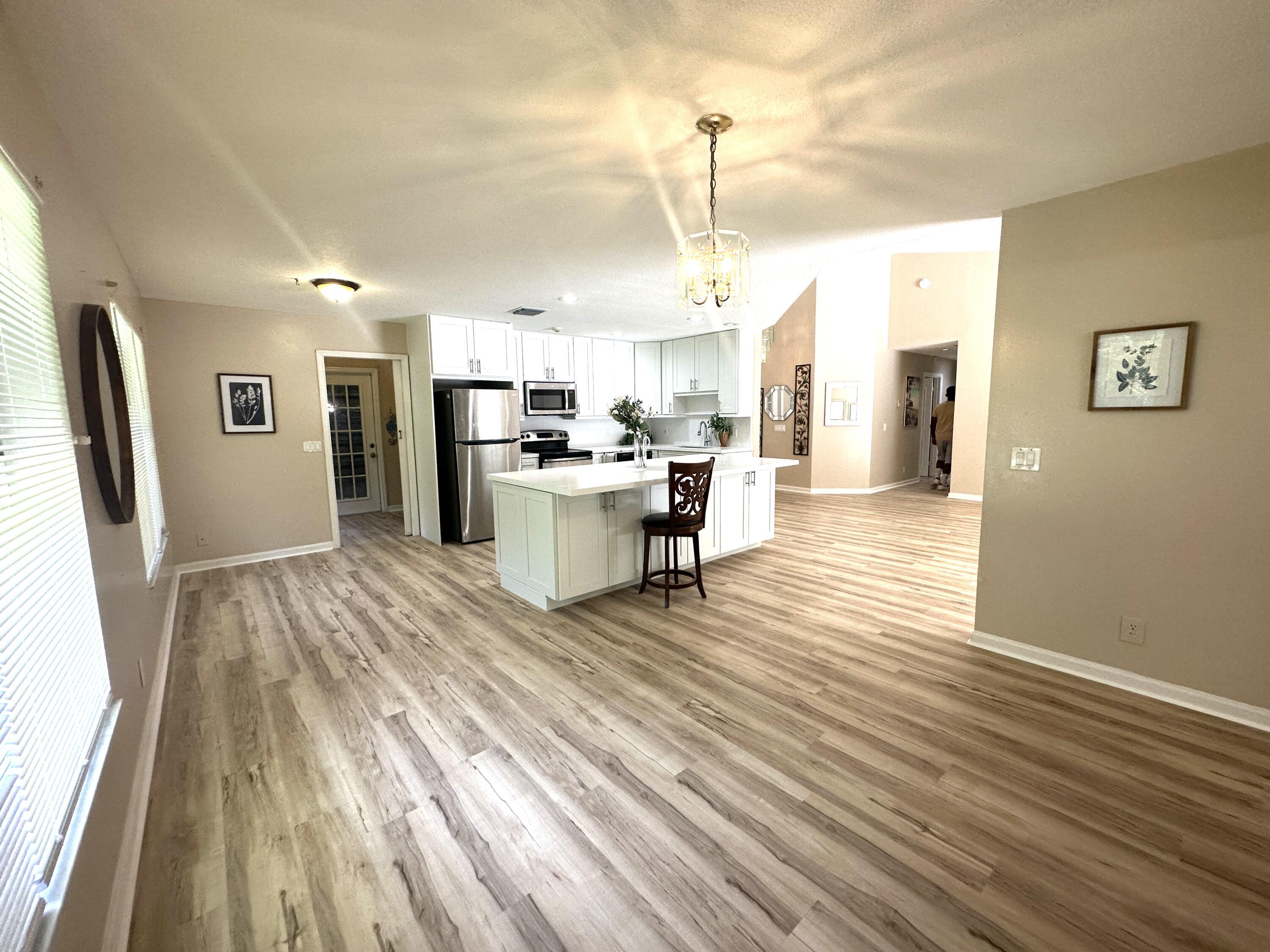 13338 76th Road North West Palm Beach, FL 33412 - Photo 7 of 138 a view of a kitchen with cabinets and wooden floor